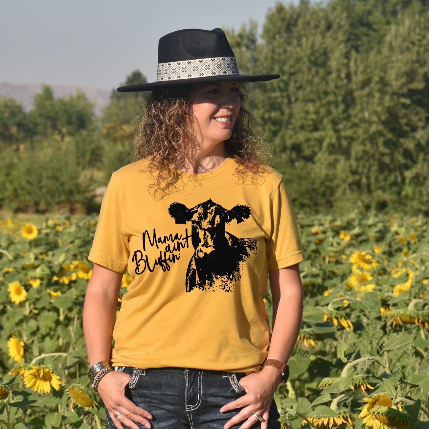 woman wearing t-shirt that says mama ain't bluffin with a picture of a cow.